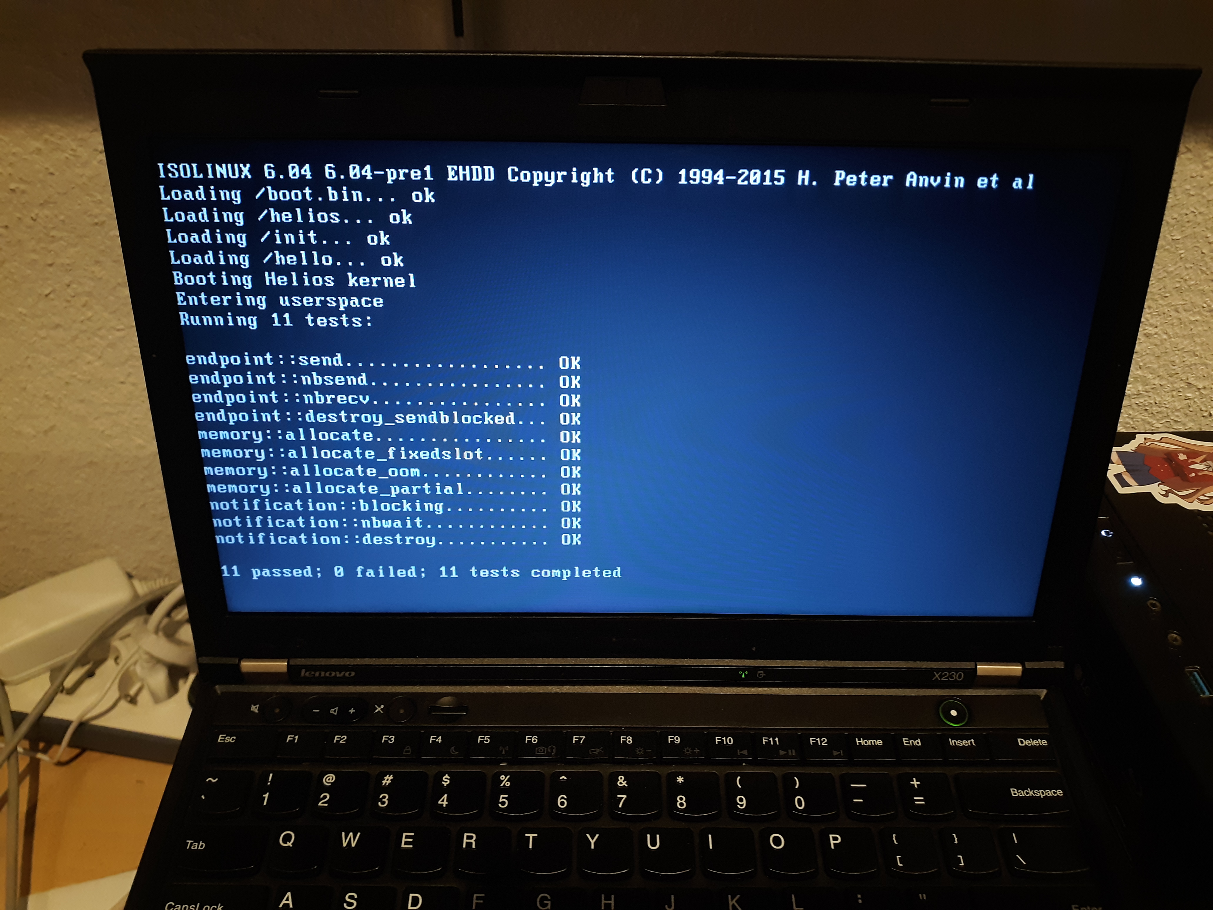 A picture of a laptop running Helios and showing the results of the Vulcan test suite