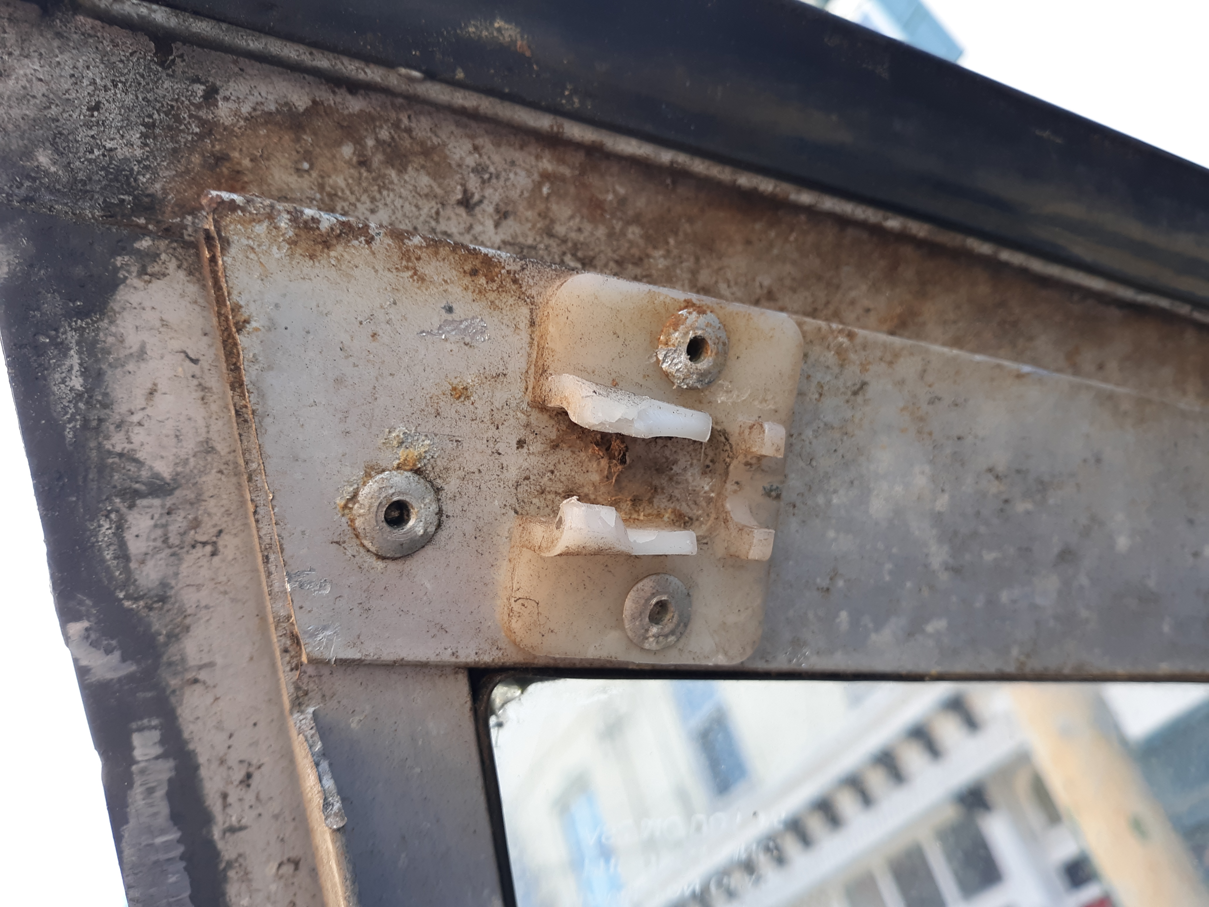 Picture of a broken latch on the window over the truck bay